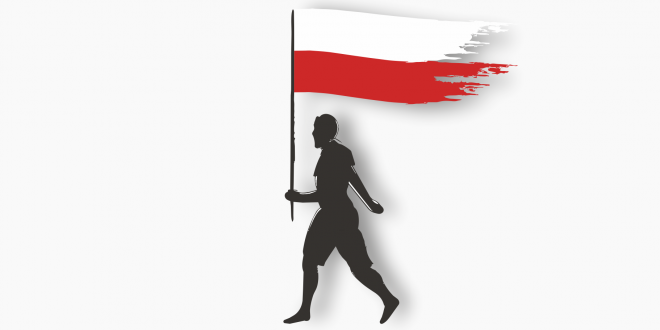 Mężczyzna idzie z polską flagą